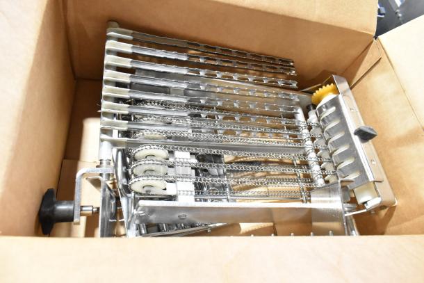 Bizerba Metal Commercial Countertop Meat Slicer Stacker, shown in a cardboard box. Features metal racks and chains, appears in excellent condition.