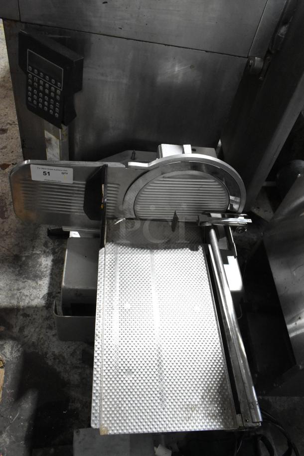 Bizerba commercial countertop meat slicer stacker in metal, showing slicer blade and textured cutting surface. Auction tag visible.