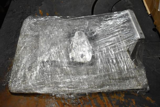 Bizerba metal commercial countertop meat slicer, wrapped in plastic, robust construction, used condition.