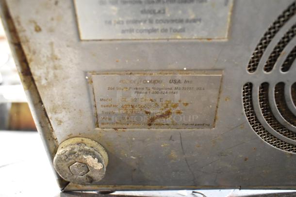 Robot Coupe CL52 commercial food processor label, 120V, model details, shows wear and dirt.