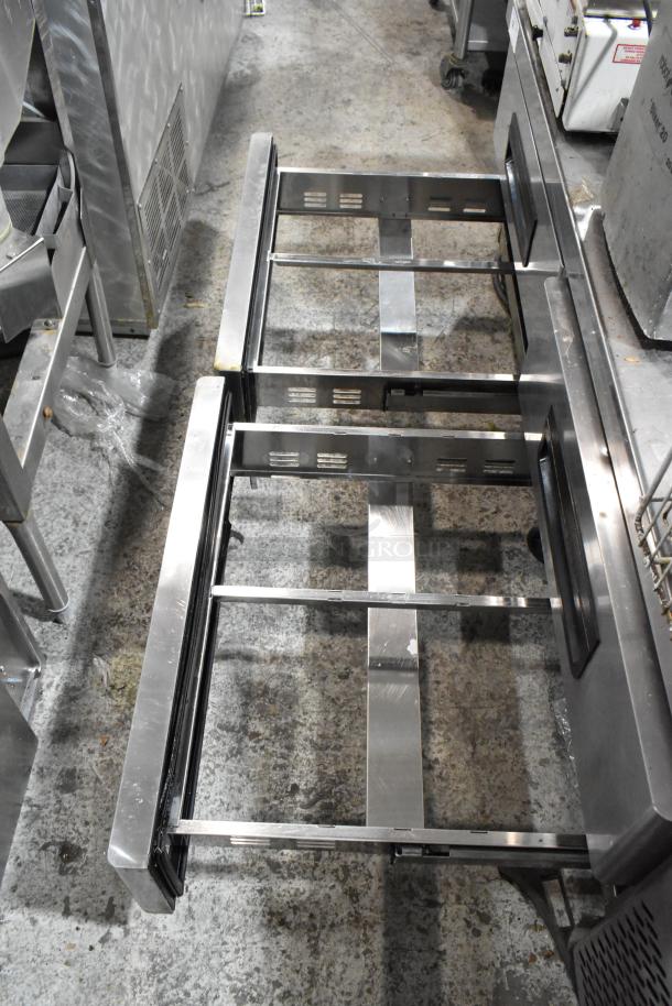 Stainless steel commercial 4-drawer chef base on casters. 115 volts, 1 phase. Good condition, durable build.