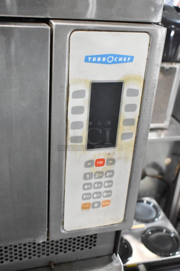 Turbochef NGC stainless steel rapid cook oven with control panel, on equipment stand with commercial casters.