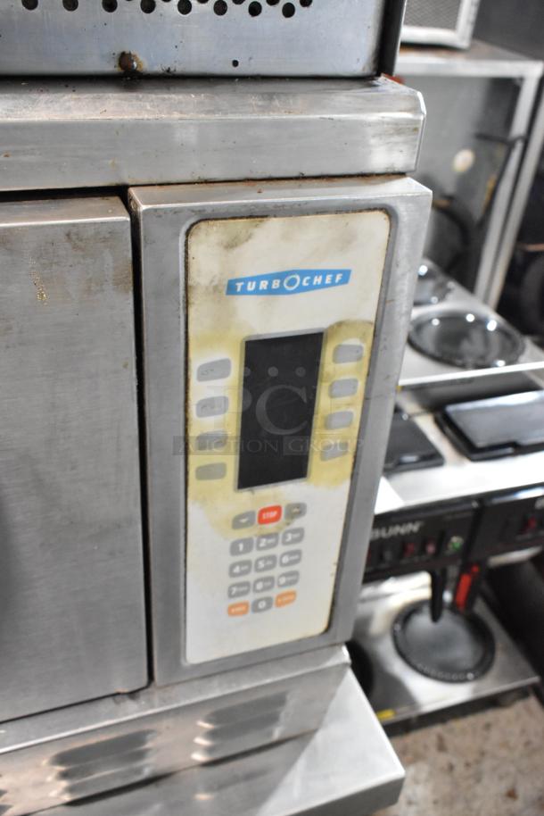 Turbochef NGC stainless steel rapid cook oven, commercial-grade, visible wear, control panel, on equipment stand with casters.