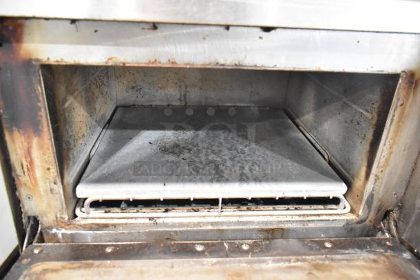 Turbochef NGC stainless steel rapid cook oven interior, showing signs of use with cooking residue, adjustable tray inside.