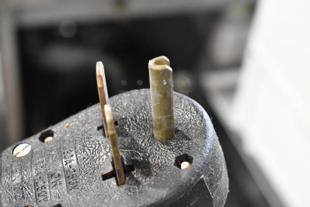 Close-up of a power plug for the Turbochef NGC commercial rapid cook oven, showing three prongs and voltage specifications.