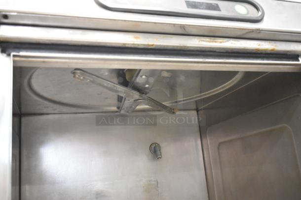 Hobart LX30H stainless steel undercounter dishwasher interior, visible wash arm and spray nozzle, commercial grade.