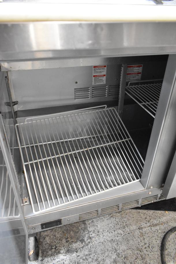 Beverage Air SPE48HC-12C stainless steel prep table, inside view, on casters, commercial use, 115V, 1 Phase.