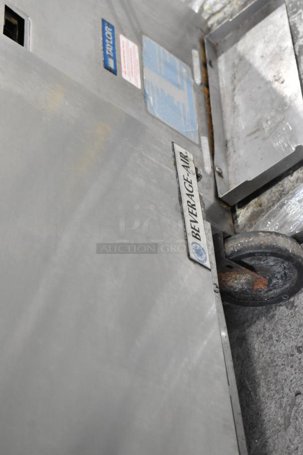 Beverage Air SPE48HC-12C stainless steel commercial prep table, visible label, on caster, used condition.