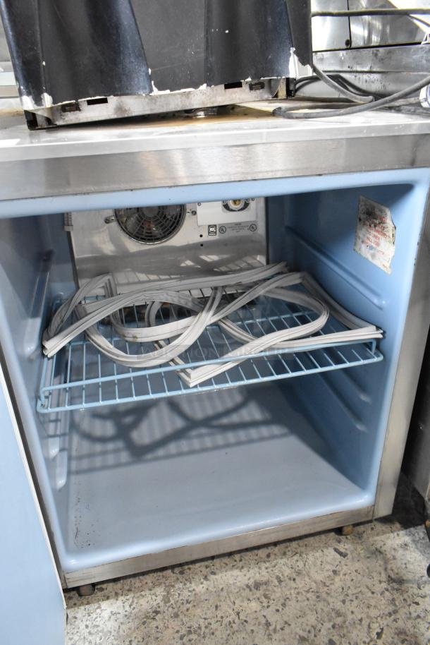 Delfield 406CA-DHL-DD1 stainless steel undercounter cooler, single door, 115V, 1 phase, interior fan, visible wear.