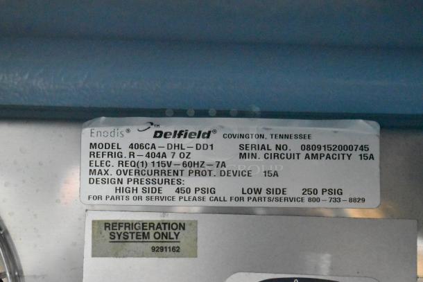 Delfield 406CA-DHL-DD1 stainless steel undercounter cooler label, showing model, serial number 0809152000745, specs, and pressures.