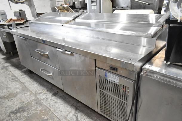 Randell 51395PR stainless steel commercial pizza prep table with 2 drawers, 2 doors, on casters. 115V, 1 phase, excellent condition.
