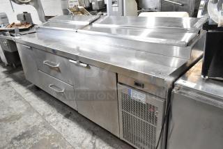 Randell 51395PR stainless steel commercial pizza prep table with 2 drawers, 2 doors, on casters. 115V, 1 phase, excellent condition.