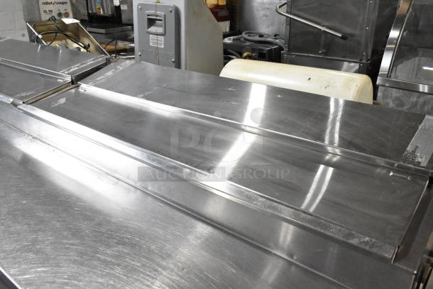 Randell 51395PR stainless steel pizza prep table with 2 drawers, 2 doors, on casters. 115V, 1 phase. Good condition.