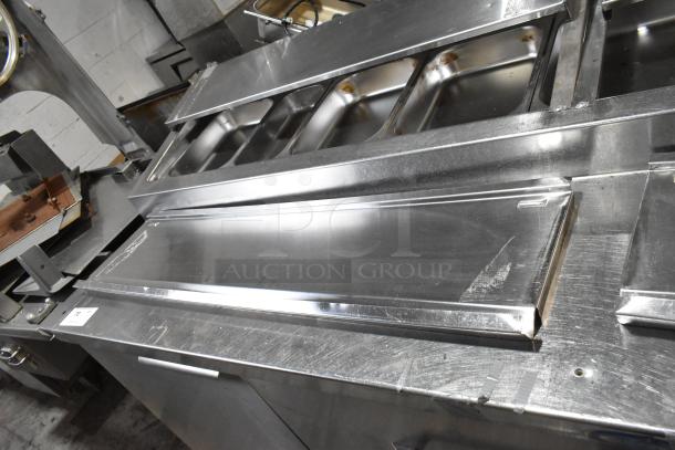 Randell 51395PR stainless steel pizza prep table with 2 drawers, 2 doors, and commercial casters. 115V, 1 Phase.