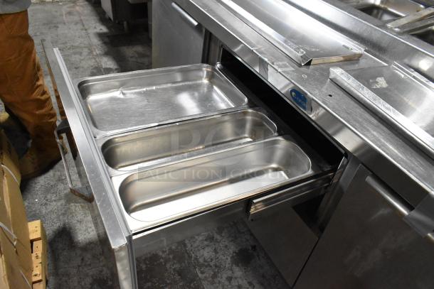 Randell 51395PR stainless steel pizza prep table with 2 drawers, 2 doors, and commercial casters, in good condition.