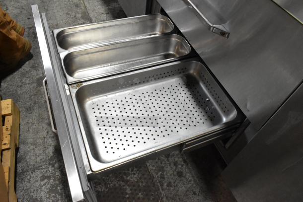 Randell 51395PR stainless steel pizza prep table with two open drawers showing perforated and solid trays.