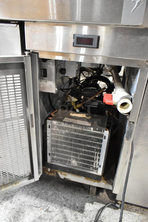 Randell 51395PR stainless steel pizza prep table with open door showing interior components, on commercial casters.