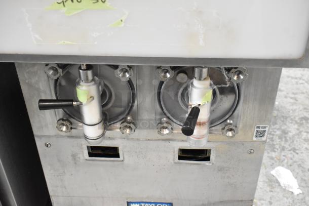 Taylor 432-27 stainless steel 2-flavor slushie machine, 208-230V, 1 phase. Visible wear, dual spouts, and manufacturer's label.