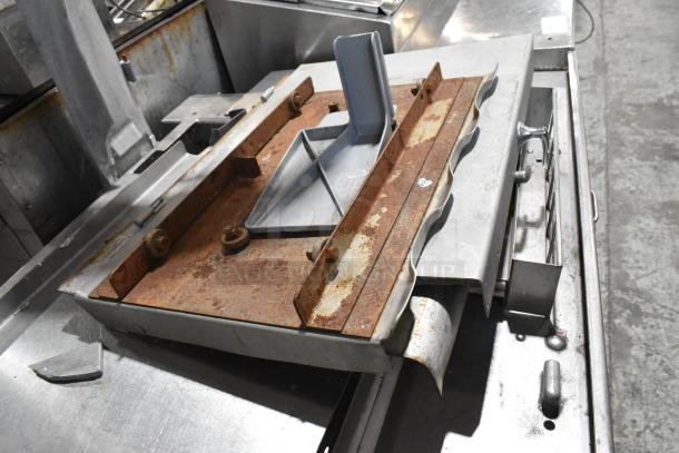 Metal commercial floor style meat saw with visible rust and wear. Includes metal components and a blue plastic guide.