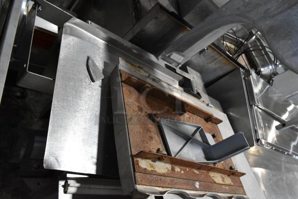 Industrial meat saw with metal frame, some rust visible, suitable for commercial use.