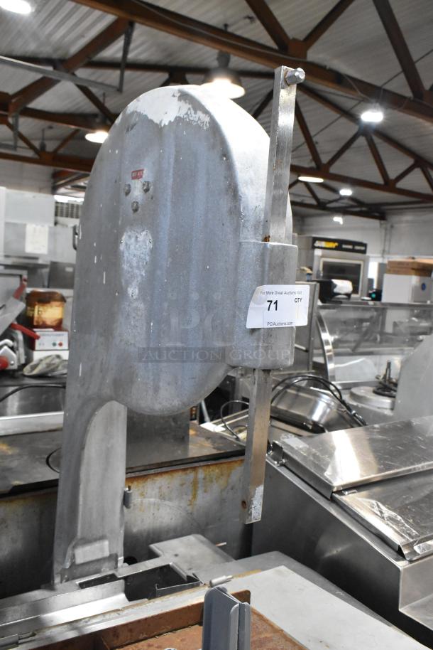 Metal commercial floor style meat saw with visible wear marks. Auction tag reads "71 QTY PCAuctions.com."