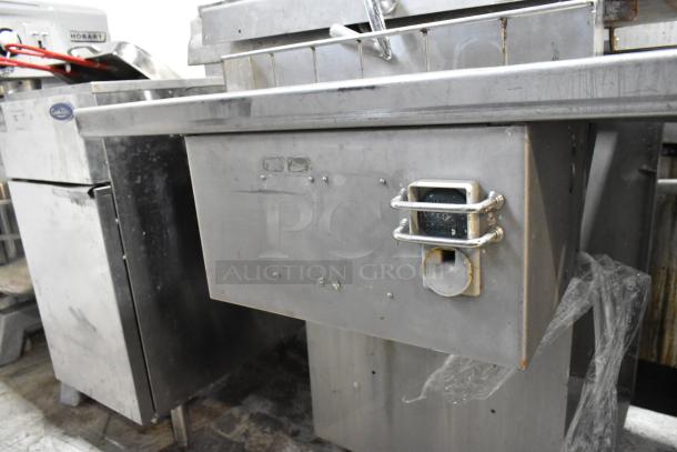 Metal Commercial Floor Style Meat Saw, made of stainless steel, in used condition with visible wear; features robust design.