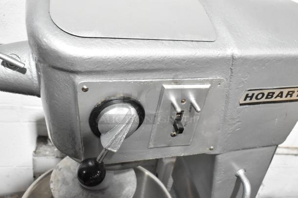 Hobart D-300 metal commercial dough mixer with control panel, stainless steel mixing bowl, and dough hook attachment.
