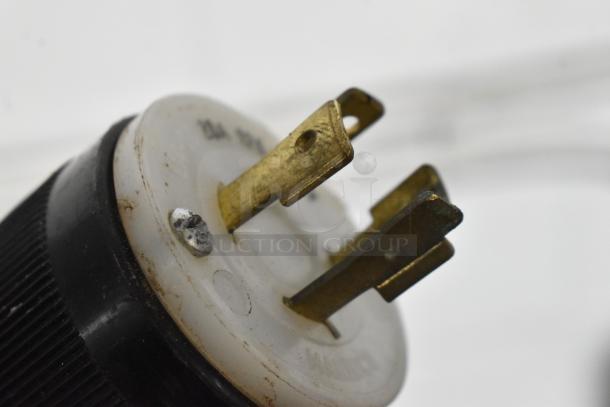 Close-up of a metal prong electrical plug for a Hobart D-300 mixer, 208 volts, 3 phase, showing brass contacts.