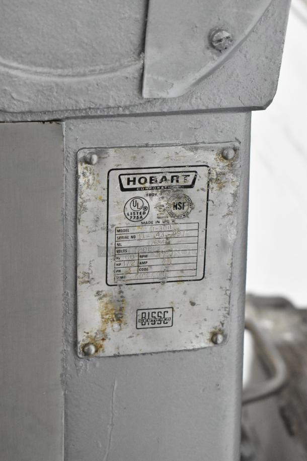 Hobart D-300 commercial mixer label showing model, serial number, volts, and other specifications. Slight wear visible.