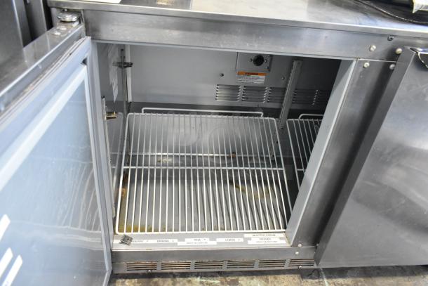 Beverage Air UCR48A stainless steel 2-door undercounter cooler, showing interior shelves and commercial casters. 115V, 1 phase.