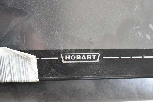 2016 Hobart HTi-7LH price computing scale with label printer, showing the Hobart logo and a partial barcode label.