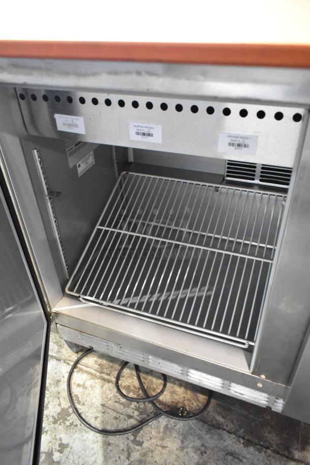 Beverage Air SPE48-18M stainless steel prep table with open shelf and commercial casters, tags for jalapeno and cheddar pretzels.