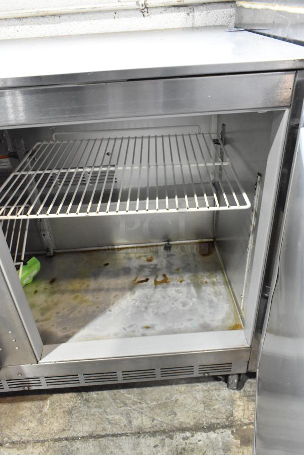 Stainless steel Beverage Air UCR48A commercial undercounter cooler, two doors, on casters, 115V, used condition, interior view.
