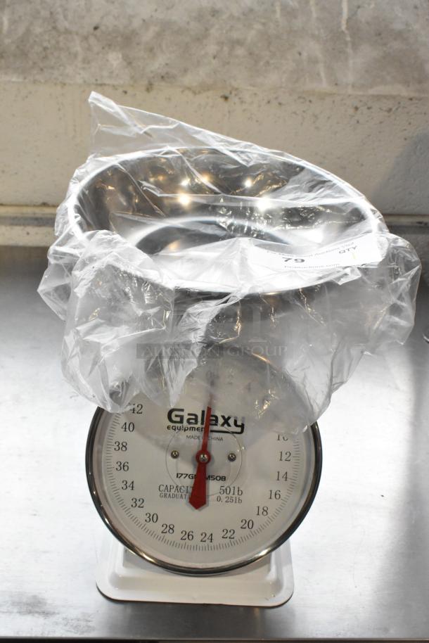 Galaxy Metal Countertop Food Portioning Scale, 50lb capacity, with clear plastic cover. Features large dial and metal bowl.