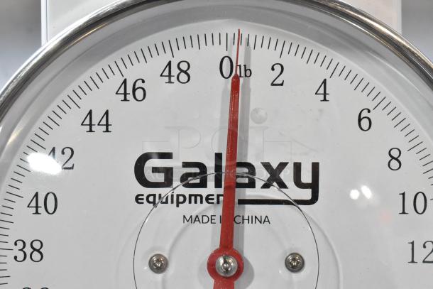 Galaxy Metal Countertop Food Portioning Scale, clear dial, red needle, Galaxy branding, "Made in China," excellent condition.