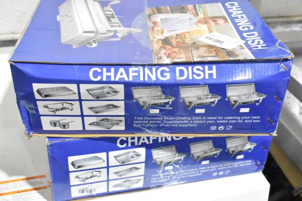 Two new metal chafers, scratch and dent condition, in original packaging. Box includes steam pan, water pan, and fuel holders.