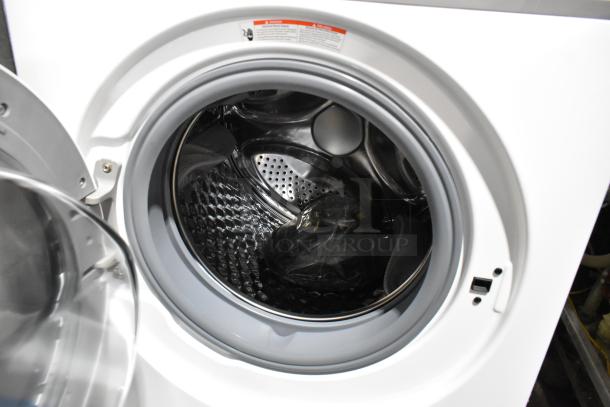 Brand new KoolMore front load washer, metal finish, open door showing drum. Scratch and dent condition.