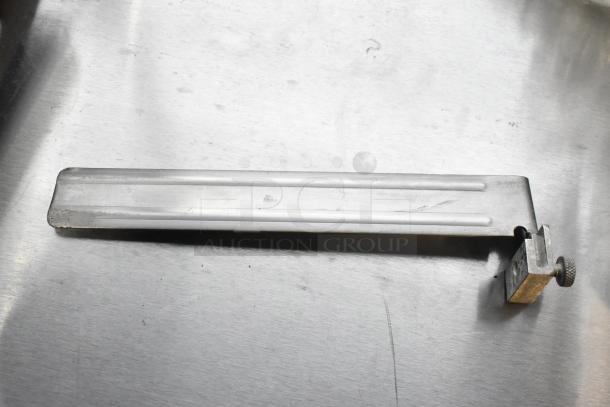 Stainless steel component of Hobart 2912 commercial meat slicer, showing mounting bracket. Appears in used condition.