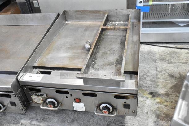 Vulcan stainless steel commercial countertop gas griddle, well-used condition, visible controls and markings, model identification tag.