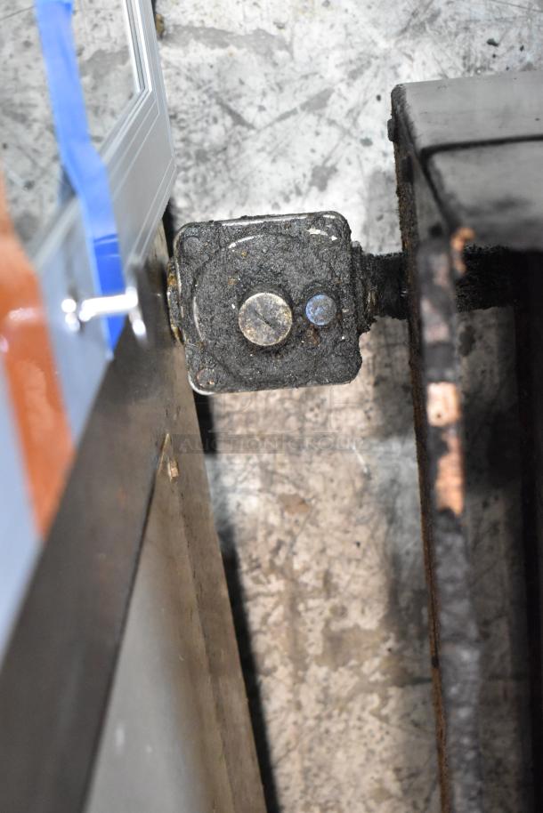 Stainless steel component of a Vulcan commercial gas griddle, showing wear and oxidation. Essential for restaurant use.