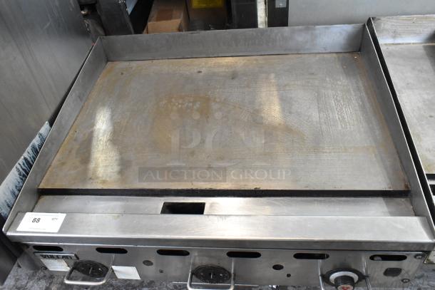 Vulcan stainless steel commercial countertop gas griddle with flat top, used condition, visible controls and ventilation slots.