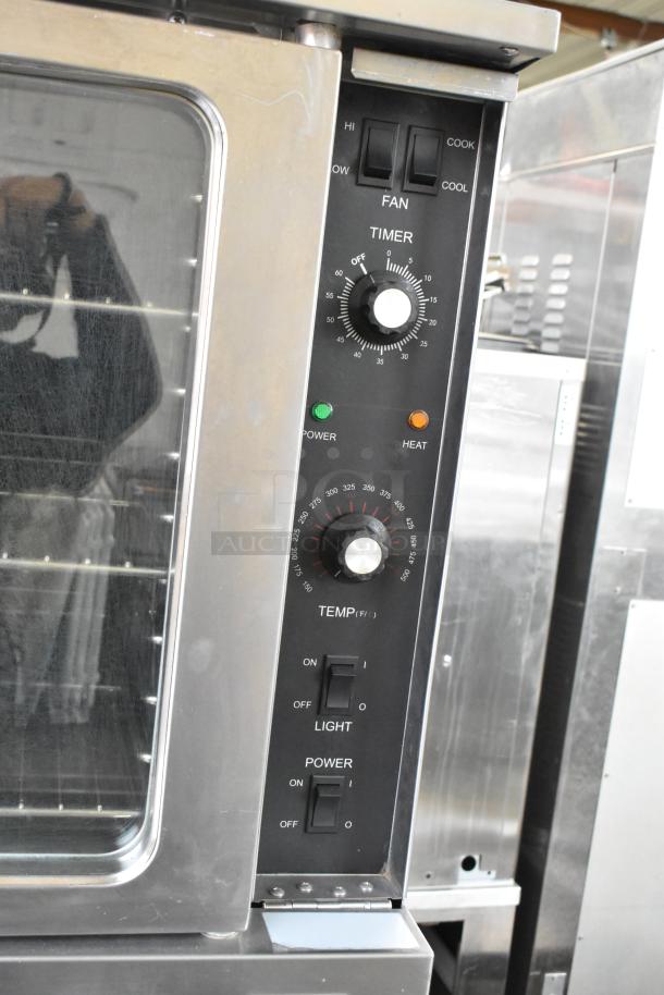 L&J NY stainless steel convection oven with view-through doors, metal racks, thermostatic controls, on commercial casters.