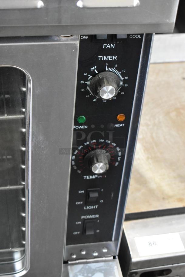 L&J NY stainless steel convection oven detail, showing controls and view-through doors; features thermostatic dials.