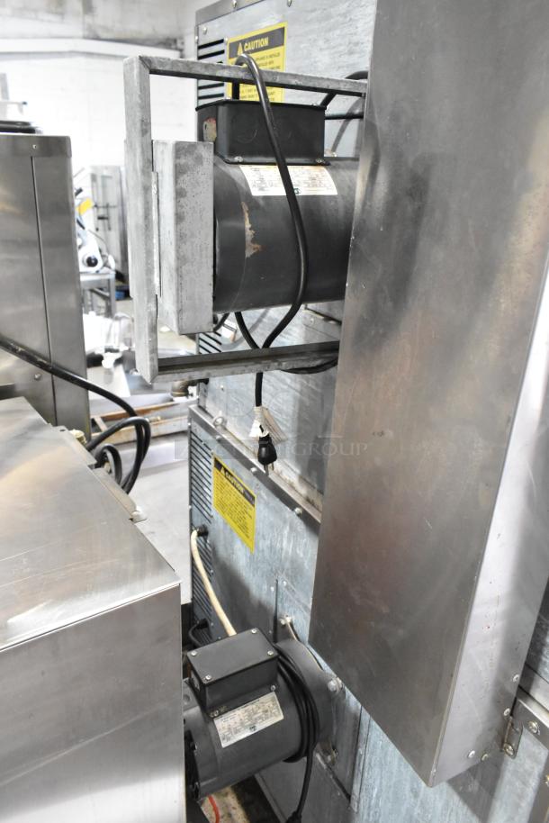 L&J NY stainless steel commercial convection oven, full-size, with view-through doors, metal racks, and thermostatic controls on casters.