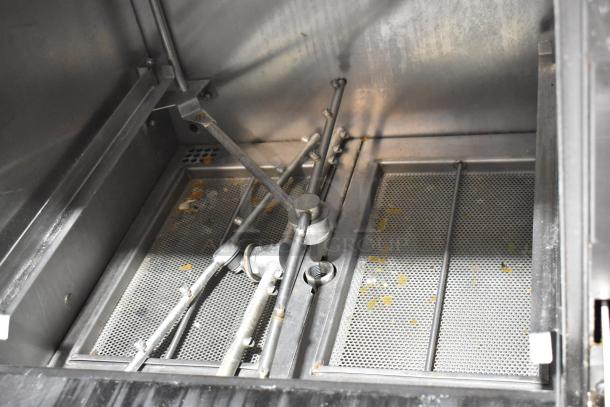 2018 Noble Wareforce UH30-E undercounter dishwasher, stainless steel interior, showing spray arms and filter condition.