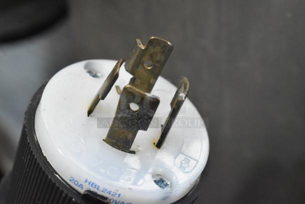 Close-up of a plug showing prongs and markings: "HBL2421, 20A 250VAC." Part of a Taylor C723-33 ice cream machine.