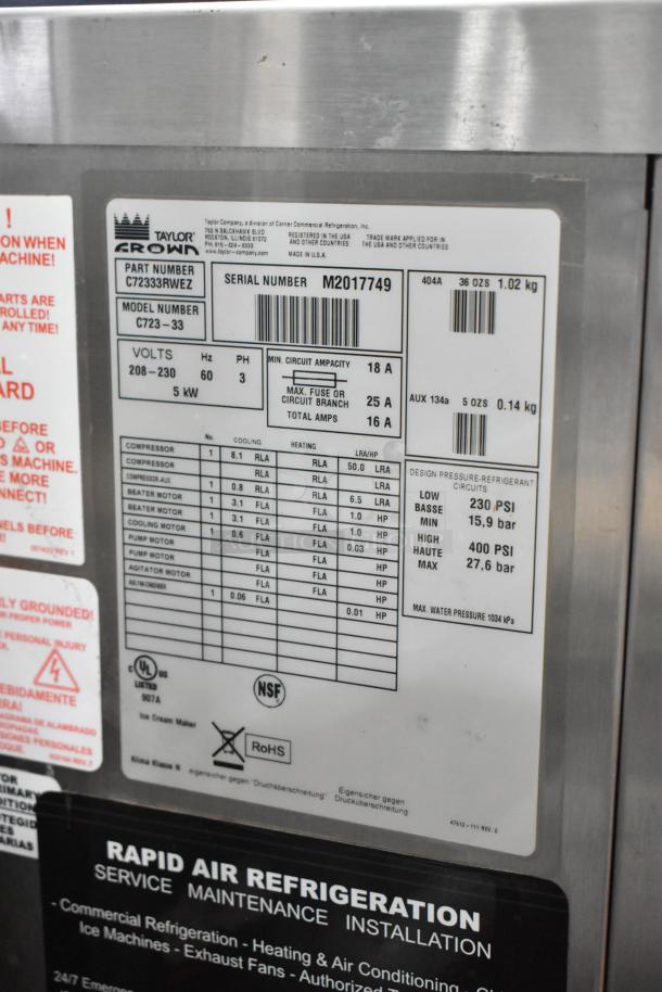 Taylor C723-33 stainless steel commercial soft serve machine, water-cooled, dual flavor with twist, on casters, 208-230V, 3-phase.