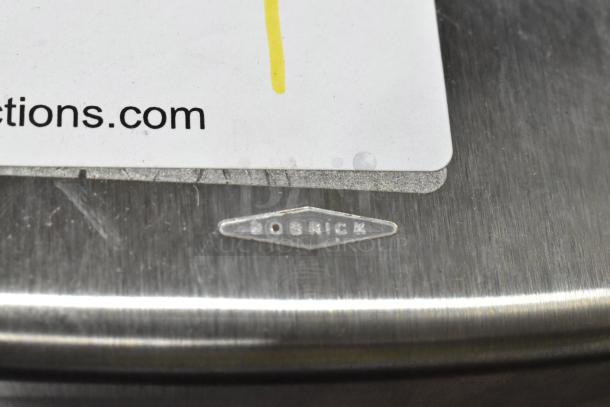 Bobrick stainless steel trash can, visible logo. Good condition, durable material. Auction item with wear marks.