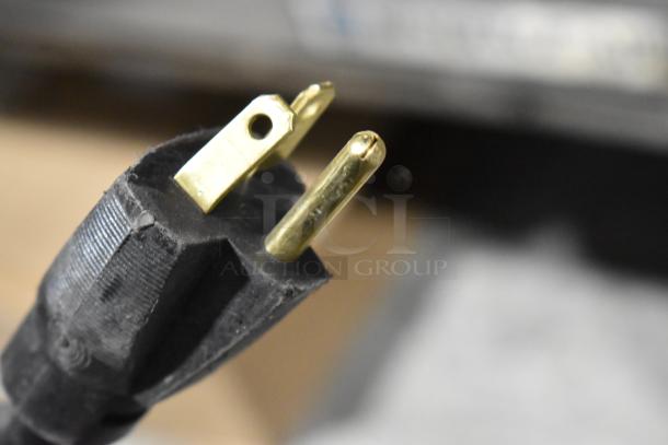 Close-up of a three-prong power plug compatible with the 2024 Bunn SINGLE SH DBC Iced Tea Machine, 120 Volts, 1 Phase.