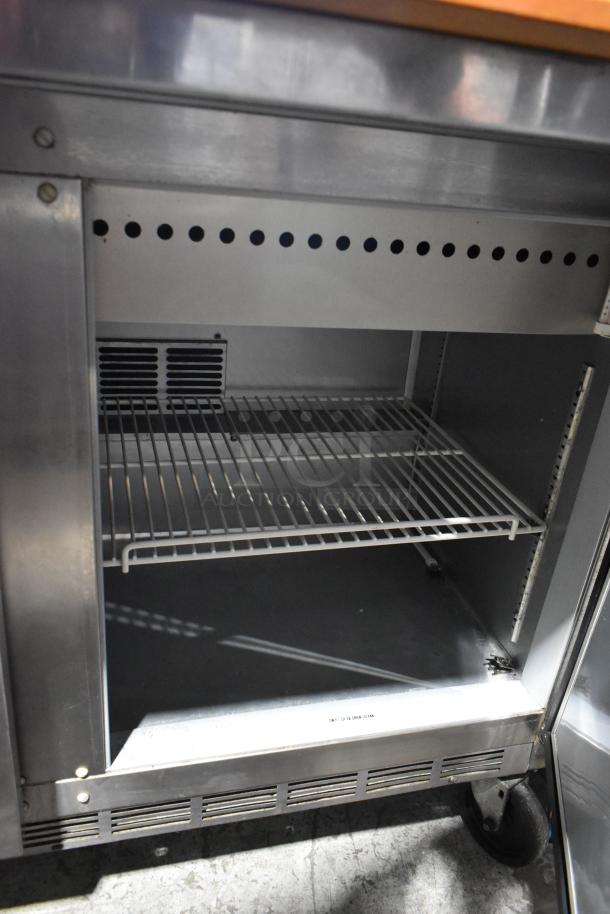 Beverage Air SPE48-18M stainless steel prep table with commercial casters, empty interior view, 115 volts, 1 phase.